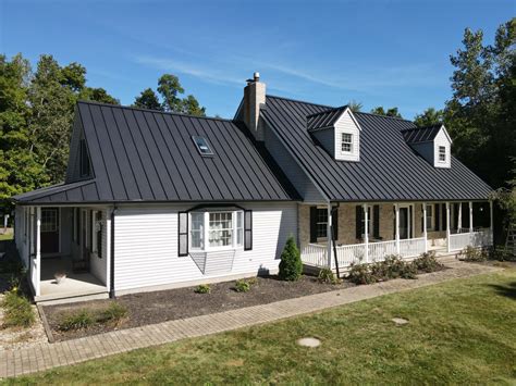 white house with black metal roof|house with black metal roof.